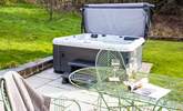 The hot tub on the patio invites you to relax and re-charge. - Thumbnail Image