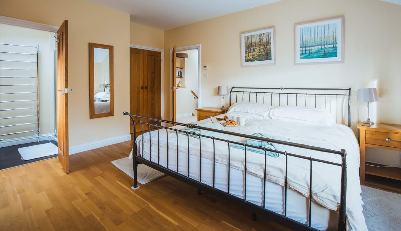 Bedroom one has built-in wardrobes and oak floors.