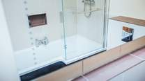 The large bathroom with shower bath.