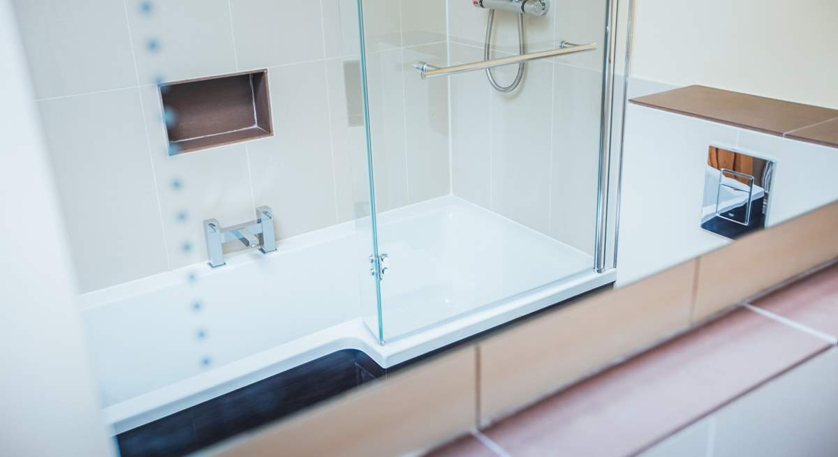 The large bathroom with shower bath.