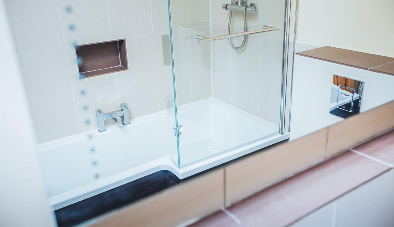 The large bathroom with shower bath.