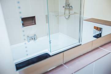 The large bathroom with shower bath.