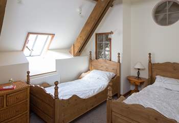Bedroom 2 has wooden twin beds.