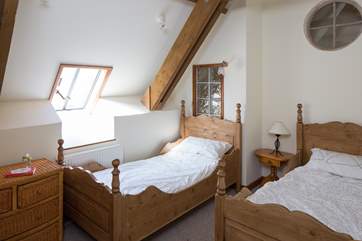 Bedroom 2 has wooden twin beds.