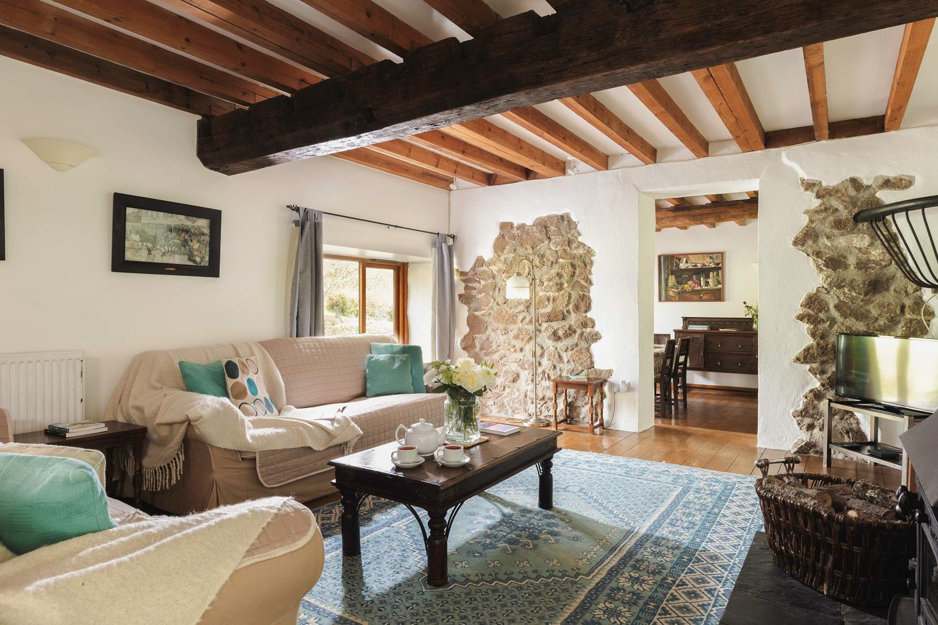 The sitting-room leads through to the dining-room.