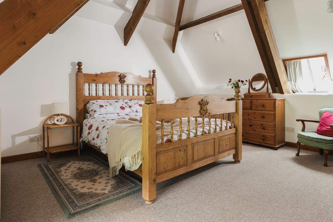 Bedroom 3 has a king-size double bed and a fabulous vaulted ceiling with exposed beams.