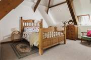 Bedroom 3 has a king-size double bed and a fabulous vaulted ceiling with exposed beams.