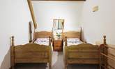 Bedroom 1 is light and airy and has twin beds. - Thumbnail Image