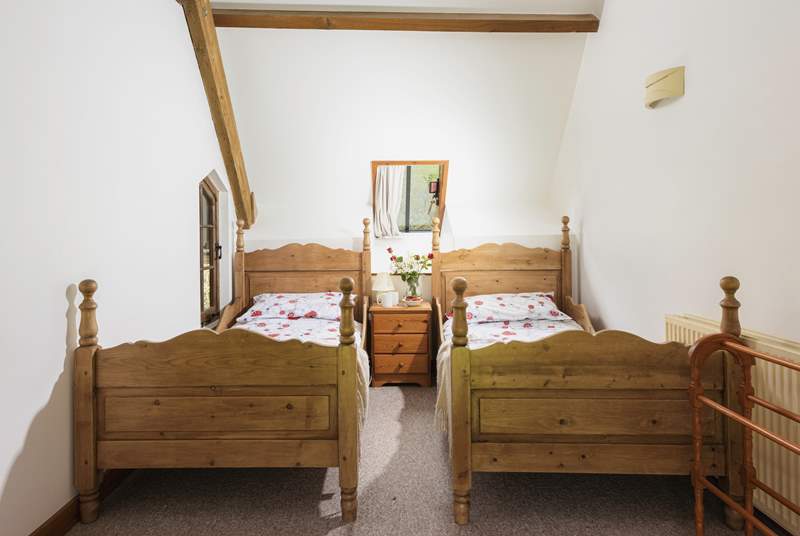 Bedroom 1 is light and airy and has twin beds.