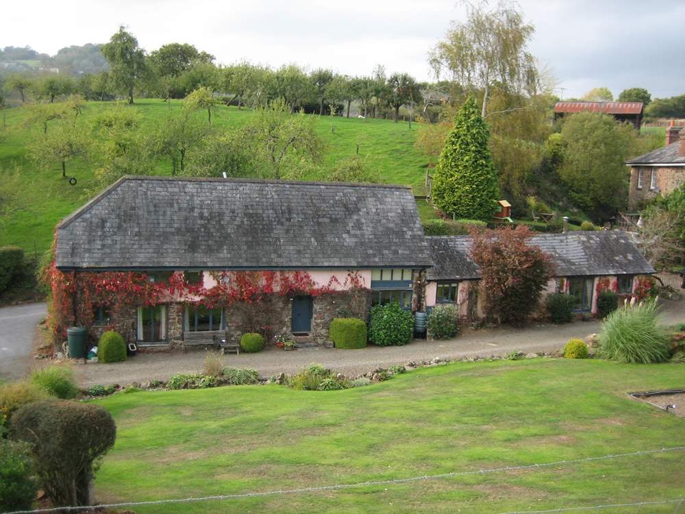 The Forge (single storey) is to the right of The Cob with the farmhouse behind - lived in by the owners.