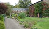 The gravelled path and stream in front of the cottages - you cannot get a car along here. There is a designated car park beyond the cottages for several cars. - Thumbnail Image