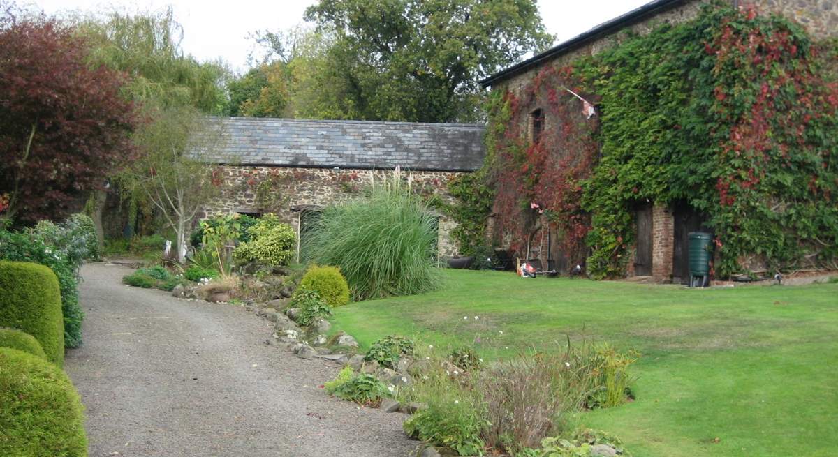 The gravelled path and stream in front of the cottages - you cannot get a car along here. There is a designated car park beyond the cottages for several cars.