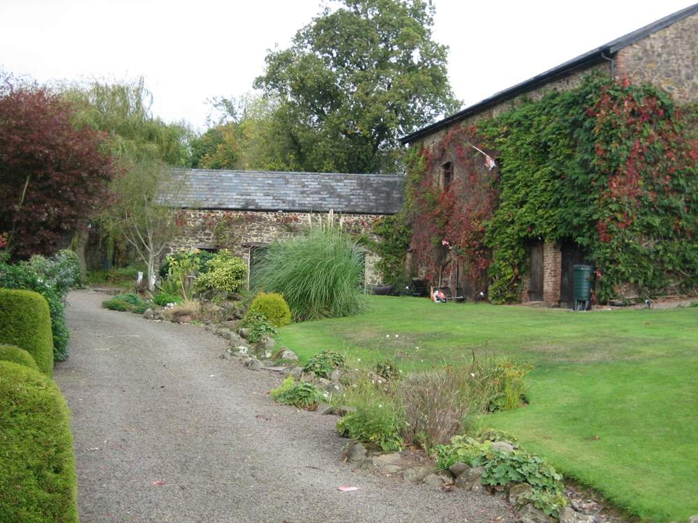 The gravelled path and stream in front of the cottages - you cannot get a car along here. There is a designated car park beyond the cottages for several cars.