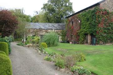 The gravelled path and stream in front of the cottages - you cannot get a car along here. There is a designated car park beyond the cottages for several cars.