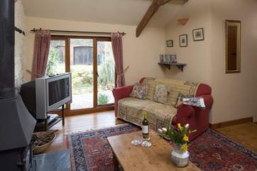 The sitting-room windows look out over the stream.