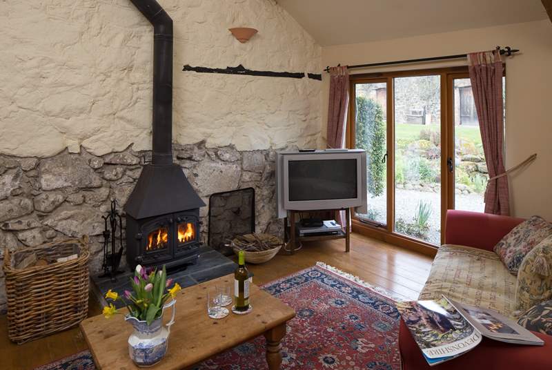The comfortable sitting-room has a cosy wood-burner.
