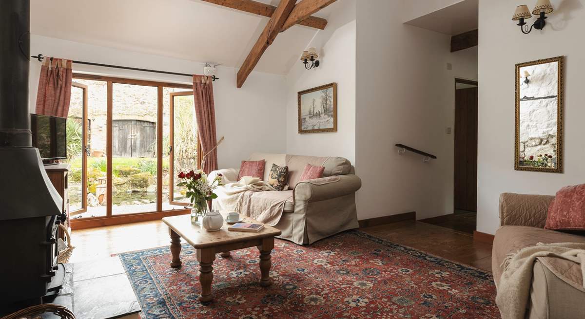 The sitting-room window looks out to the stream.