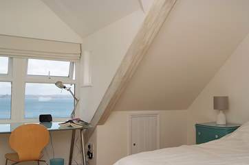 The second floor bedroom has a desk with stunning views to the sea.