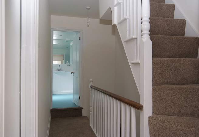 The first floor landing leads to the bathroom and very steep stairs go up to the second floor bedroom.