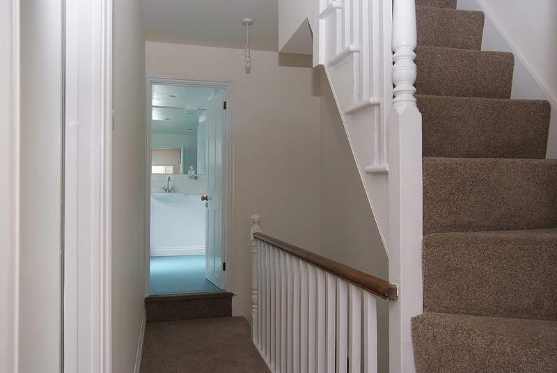 The first floor landing leads to the bathroom and very steep stairs go up to the second floor bedroom.