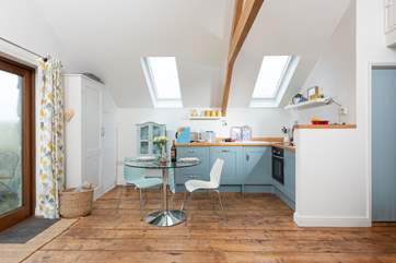 The lovely kitchen-dining area with doors leading out onto the terrace.