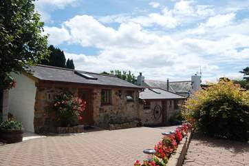The Hideaway is the whole of this pretty barn conversion, with the bedroom on the upper level and the kitchen and sitting-room a few steps below.