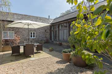 The courtyard seating-area captures the sunshine for most of the day and has been made to feel very private and sheltered with attractive planting.