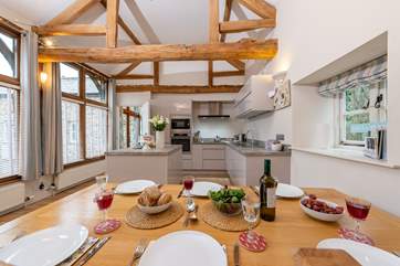 There is a high ceilinged open plan kitchen/dining-room.