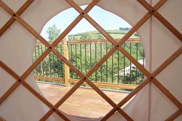 Peeking through Poppy's window across the decking to the rolling countryside beyond. Ashley's Shack, also on site, can be seen to the right.