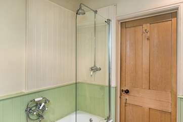 The bathroom has a fitted shower over the bath.