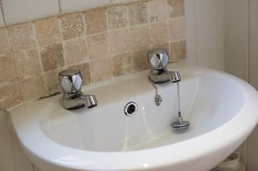 There is a wash-basin with hot and cold running water.