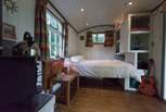 A comfortable double bed is tucked into one end of the shepherd's hut - the en suite is at the other.