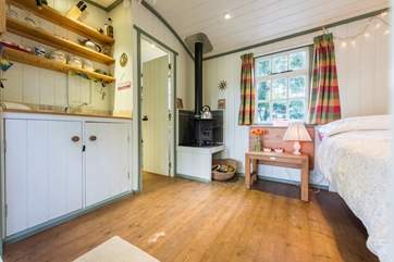 There is a little dining-area next to the wood-burner in the cheerful and cosy interior.
