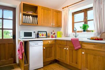 The well-equipped kitchen-area enjoys views over the garden.