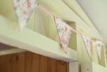 There is pretty bunting around the cabin bed.