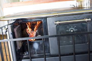 The log-fired range is your heating and cooking appliance, but the owners have thoughtfully provided a gas camping stove out on the balcony too.
