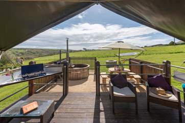 Relax on the decking whilst the children enjoy the space and freedom of this glamping site.