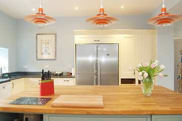 The island unit has plenty of space for cooks to gather and the big American-style fridge/freezer has plenty of storage space (backed up by a second fridge in the drinks corner).