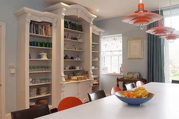This massive vintage dresser houses all the tableware so its easy to set the table for your meals and a dishwasher at this end of the island unit means it's easy to clear away afterwards!