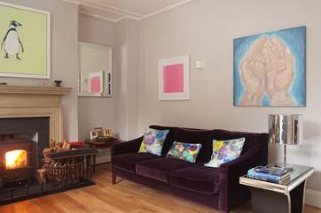 Gorgeous fabrics in wonderful colours mix with an eclectic mix of artwork throughout the house.