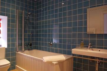 The family bathroom on the first floor has a bath with a fitted shower over.