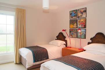 Bedroom 5 has twin beds and looks out over the garden and meadow to the rear.