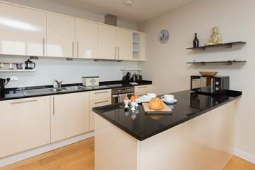 There is a very well-equipped and stylish kitchen in one corner of this amazing room.