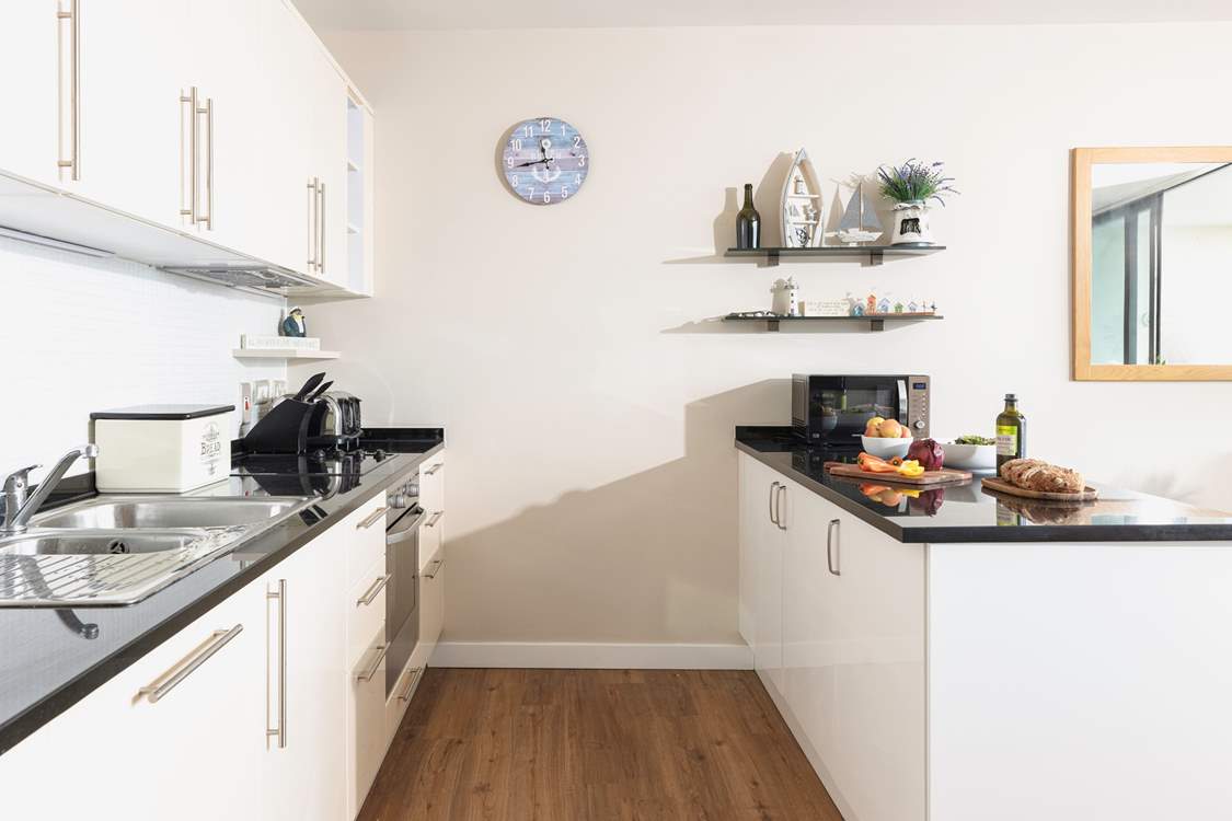 There is a very well-equipped and stylish kitchen in one corner of this amazing room.