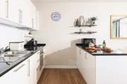 There is a very well-equipped and stylish kitchen in one corner of this amazing room.