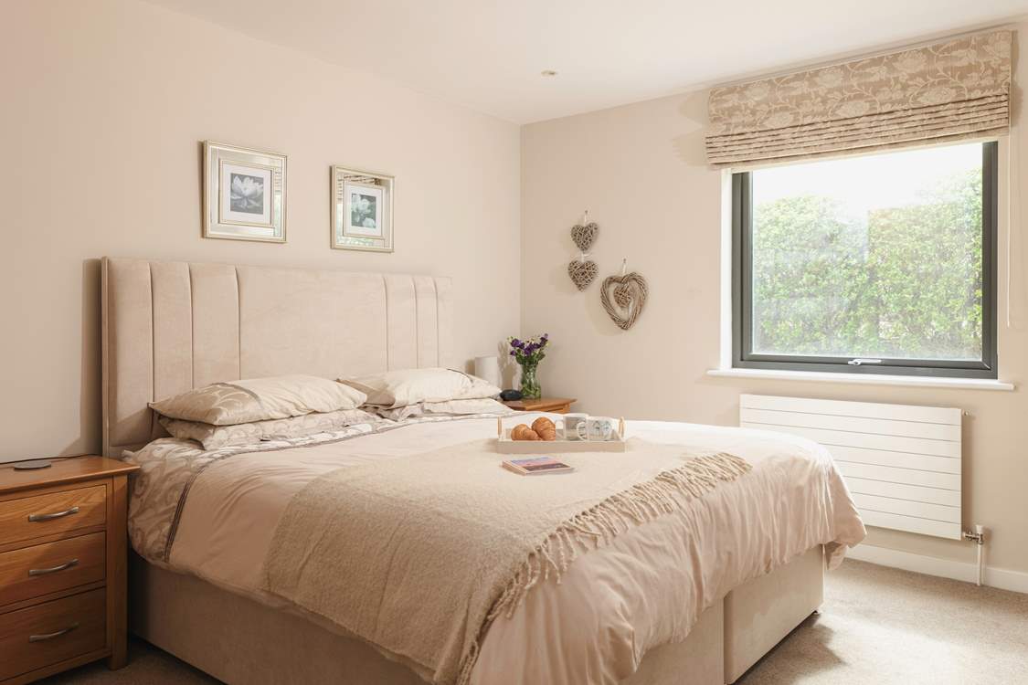 This lovely tranquil bedroom with its super-king double bed offers the perfect spot to recharge after playing on the beach.