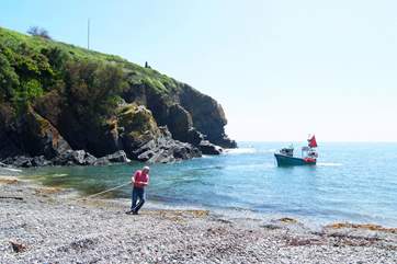 Working fishing boats come and go with the tides.