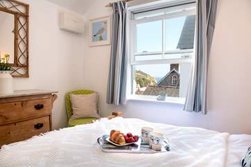 The bedroom has a glimpse of the sea, open the window to hear the waves lapping in the cove.
