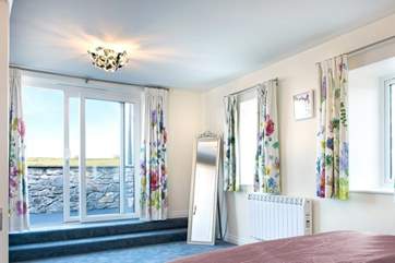 Sliding doors lead out from the bedroom to the balcony where you enjoy more of those fabulous views