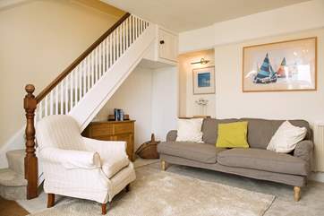 The stairs to the first floor lead up from the sitting-room.